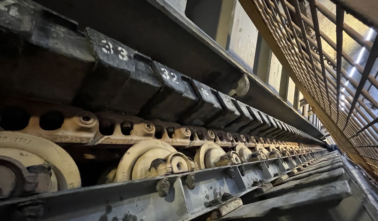 Apron feeder pans numbered in sequence along a fixed plant conveyor run.